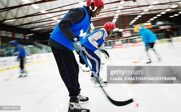 Somali players take part in the Somali national Bandy team's training session on September 24, 2013 in the city of Borlaenge, Sweden. Somali refugees...