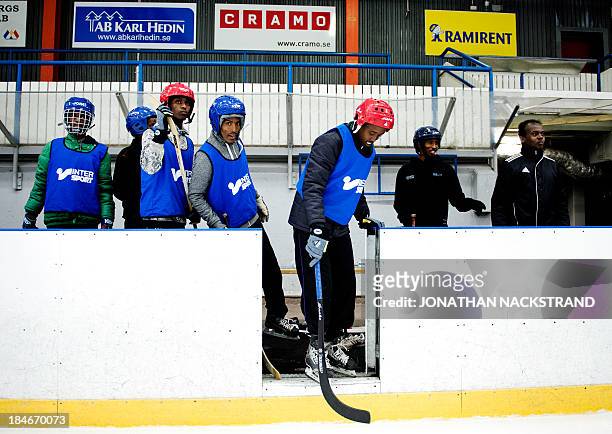 Somali players prepare to step down to the ice during the Somali national Bandy team's training session on September 24, 2013 in the city of...