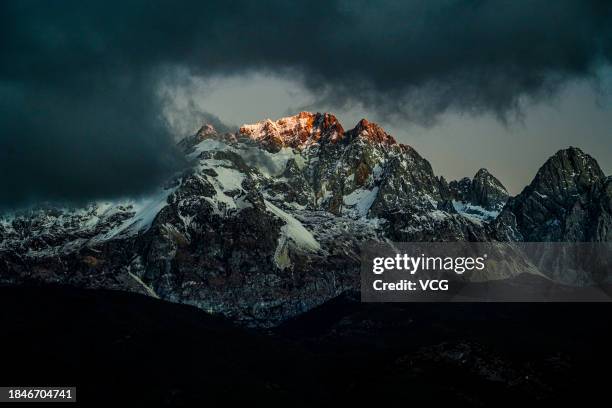 Golden sun rays shine over the Yulong Snow Mountain on December 10, 2023 in Lijiang, Yunnan Province of China.