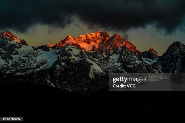 Golden sun rays shine over the Yulong Snow Mountain on December 10, 2023 in Lijiang, Yunnan Province of China.