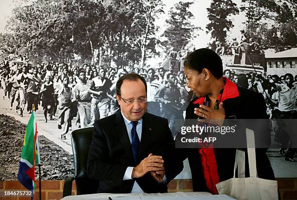 French President Francois Hollande chats with Antoinette Sithole, sister of the first victim of the June 16 Soweto uprising Hector Pietersen, during...