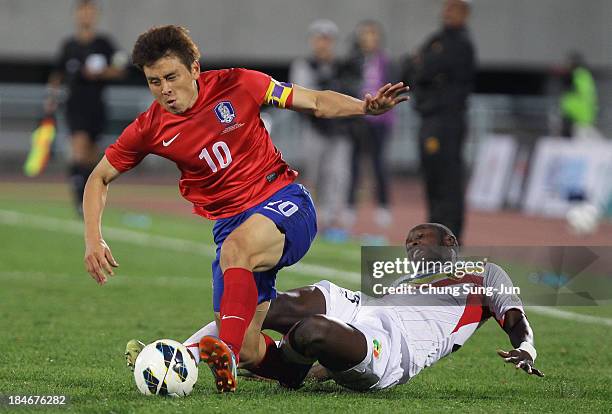 Koo Ja-Cheol of South Korea competes for the ball with Ousmane Coulibaly of Mali during the international friendly match between South Korea and Mali...