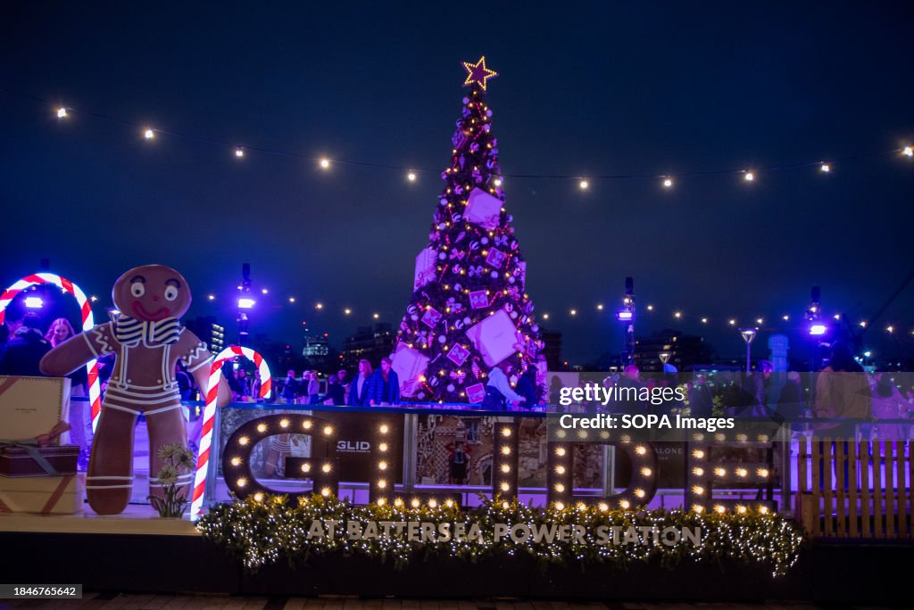 Gingerbread man stands with candy canes by the name of the...