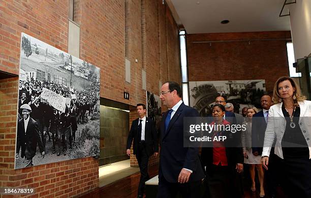French President François Hollande walks in front of Antoinette Sithole, sister of the first victim of the June 16 Soweto uprising Hector Pietersen ,...