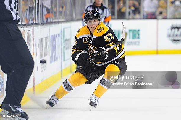 Torey Krug of the Boston Bruins dumps the puck down the ice against the Colorado Avalanche at the TD Garden on October 10, 2013 in Boston,...