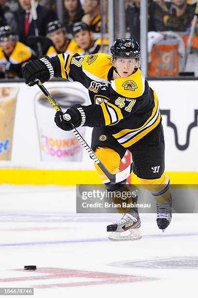 Torey Krug of the Boston Bruins passes the puck against the Colorado Avalanche at the TD Garden on October 10, 2013 in Boston, Massachusetts.