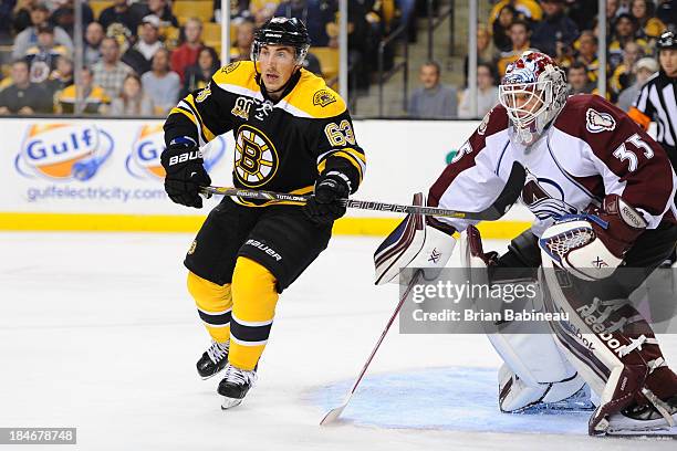 Brad Marchand of the Boston Bruins watches the play against Jean-Sebastien Giguere of the Colorado Avalanche at the TD Garden on October 10, 2013 in...