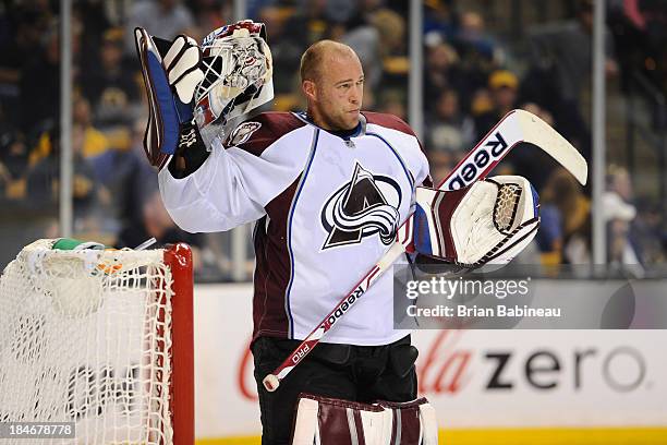 Jean-Sebastien Giguere of the Colorado Avalanche puts his helmet on during a time out against the Boston Bruins at the TD Garden on October 10, 2013...