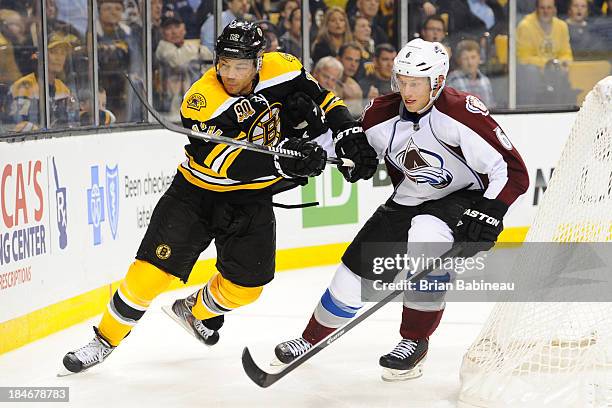 Jarome Iginla of the Boston Bruins skates against Erik Johnson of the Colorado Avalanche at the TD Garden on October 10, 2013 in Boston,...