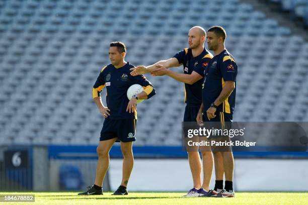 Michael O'Loughlin coach of the AFL Australian International Rules team chats with his assistants Andrew McLeod and Tadgh Kennelly during a training...