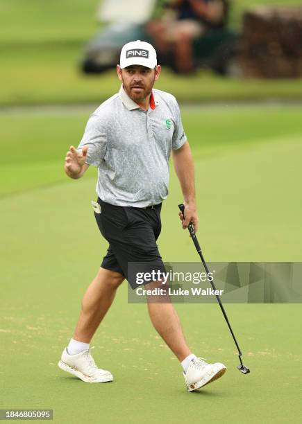 Louis Oosthuizen of South Africa acknowledges the crowd following a birdie putt on the 14th green on Day Five of the Alfred Dunhill Championship at...