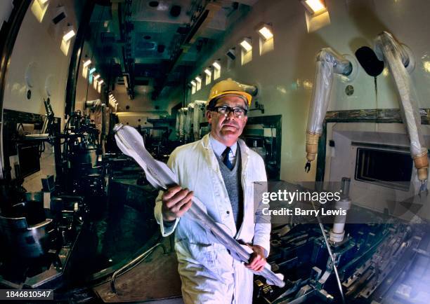 Chemical engineer testing a dummy fuel rod inside a 'decanning room' about to be commisioned in Sellafield nuclear site on 9th September 1985 in...