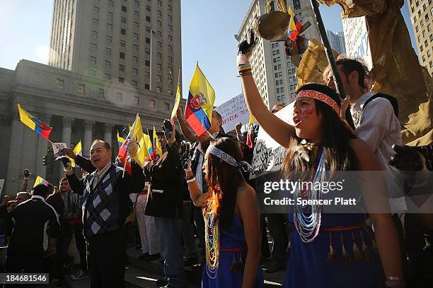 Following an $18 billion judgment against Chevron from a court in Ecuador, protesters, some in traditional dress and with black hands representing...