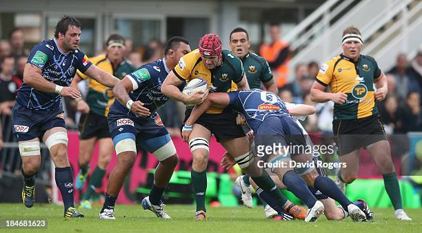 Christian Day of Northampton is tackled during the Heineken Cup match between Castres and Northampton Saints at Stade Pierre Antoine on October 12,...