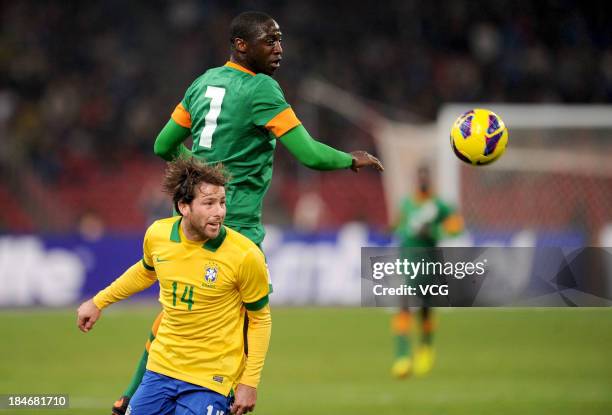 Maxwell of Brazil and Mukaka Mulenga of Zambia battle for the ball during the international friendly match between Brazil and Zambia at Beijing...