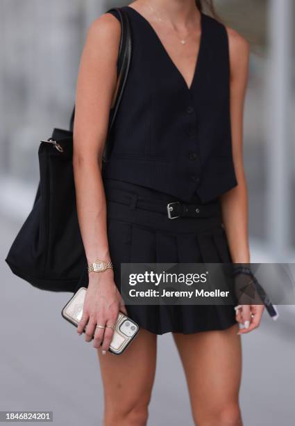 Elle Chen seen wearing black pinstripe suit gilet, matching black checked belted pleated short skirt, Longchamp black nylon shopper bag, Cartier...