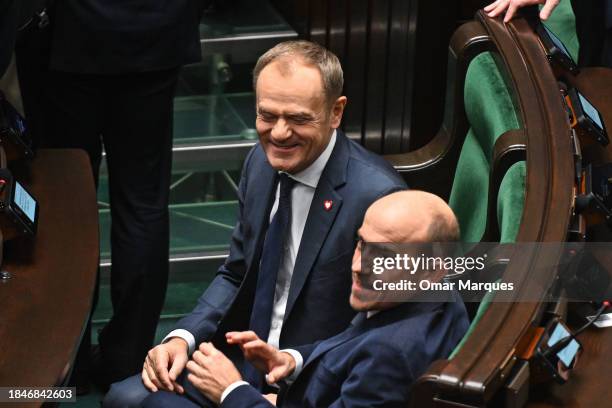 The leader of Civic Coalition , Donald Tusk stands among member parties as the Prime Minister, Mateusz Morawiecki delivers a speech during a...