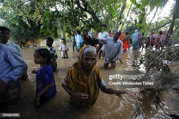 Unnyan distributing ready food to Villagers of Gopinath Pura, who are staying near Subarnarekha River after the cyclone Phailin on October 15, 2013...