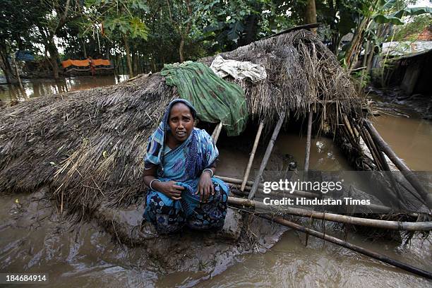 Woman sit near her hut destroyed in flood after the cyclone Phailin at Gopinath Pura on October 15, 2013 about 20 kilometers north of Balasore,...