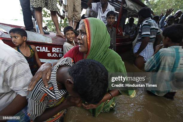 Unnyan distributing ready food to Villagers of Gopinath Pura, who are staying near Subarnarekha River after the cyclone Phailin on October 15, 2013...