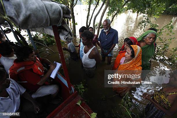 Unnyan distributing ready food to villagers of Gopinath Pura, who are staying near Subarnarekha River after the cyclone Phailin on October 15, 2013...