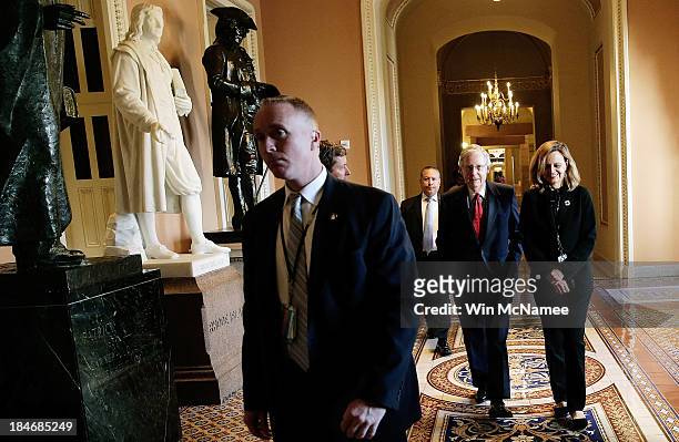 Senate Minority Leader Mitch McConnell walks to a meeting of the Senate Republican caucus with his chief of staff, Sharon Soderstrom , October 15,...
