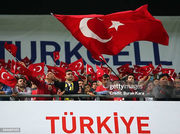 Fans of Turkey wave the Turkish flag during FIFA 2014 World Cup Qualifier match at the Sukru Saracoglu Stadium on October 15, 2013 in Istanbul,...