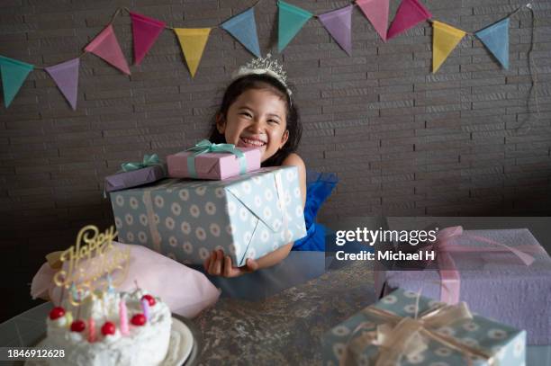 girl holding a birthday party in the living room - boy tiara stock pictures, royalty-free photos & images