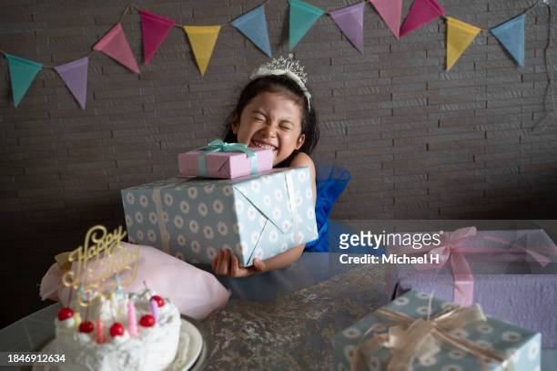 girl holding a birthday party in the living room - boy tiara stock pictures, royalty-free photos & images