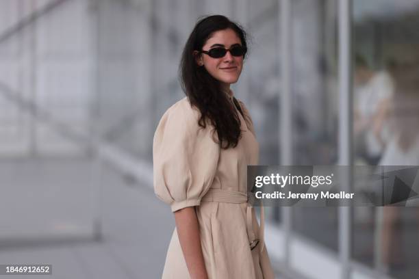 Isabella Gosen seen wearing Le Specs brown tortoise oval sunglasses, gold earrings, beige linen belted short dress with puff sleeves, silver watch,...