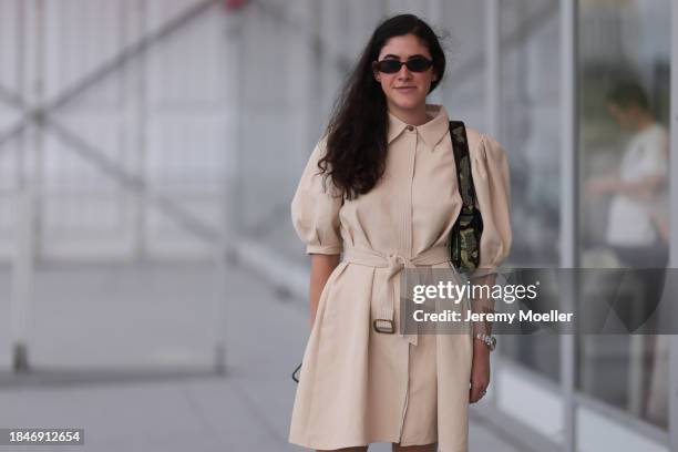 Isabella Gosen seen wearing Le Specs brown tortoise oval sunglasses, gold earrings, beige linen belted short dress with puff sleeves, silver watch,...