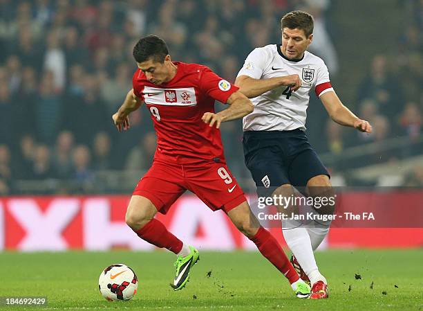 Robert Lewandowski of Poland breaks away from Steven Gerrard of England during the FIFA 2014 World Cup Qualifying Group H match between England and...
