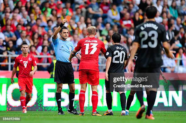 Aurelien Joachim of Luxembourg is shown a red card by the referee Bulent Yildiriem during the FIFA 2014 World Cup Qualifier match between Portugal...