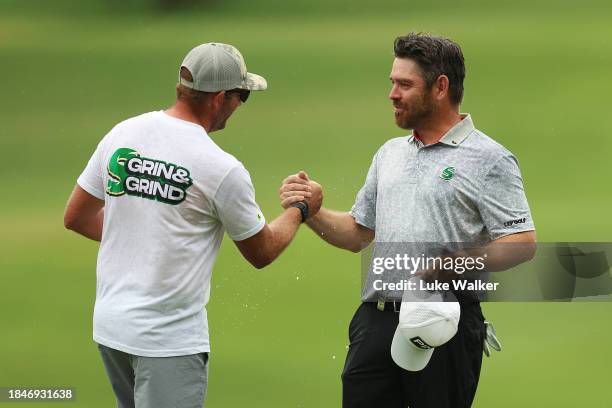 Louis Oosthuizen of South Africa celebrates with Dean Burmester of South Africa on the 18th green on Day Five of the Alfred Dunhill Championship at...