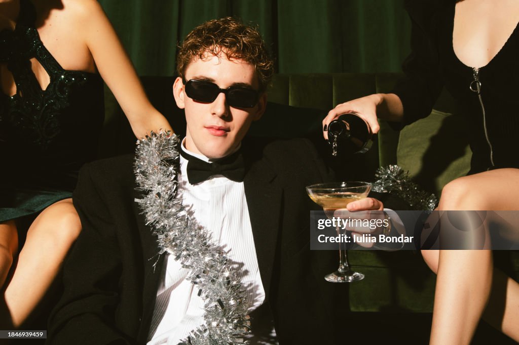 Young man with ladies celebrating New Year's eve
