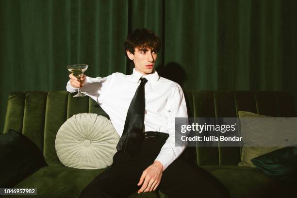 young man having a champagne - moda foto e immagini stock