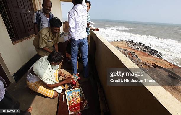 Policemen collecting ravaged remains at the Odishas only marine police station at Arjapalli after it was hit by the cyclone Phailin on October 15,...