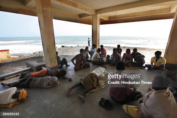 Cyclone victims taking shelter at the Odishas only marine police station at Arjapalli after cyclone Phailin on October 15, 2013 about 190 kilometers...