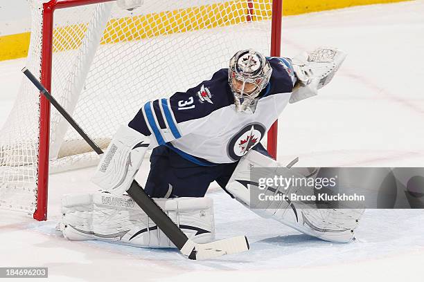 Ondrej Pavelec of the Winnipeg Jets defends his goal against the Minnesota Wild during the game on October 10, 2013 at the Xcel Energy Center in St....