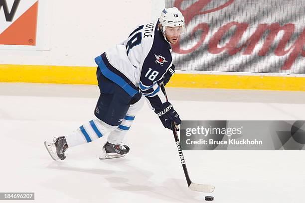 Bryan Little of the Winnipeg Jets skates with the puck against the Minnesota Wild during the game on October 10, 2013 at the Xcel Energy Center in...