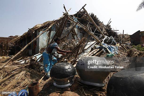 Indian fishermen family trying to salvage things from their damaged houses after cyclone Phailin in Podampetta village on October 15, 2013 about 190...