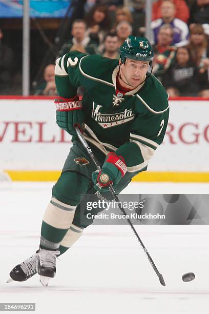 Keith Ballard of the Minnesota Wild skates with the puck against the Winnipeg Jets during the game on October 10, 2013 at the Xcel Energy Center in...