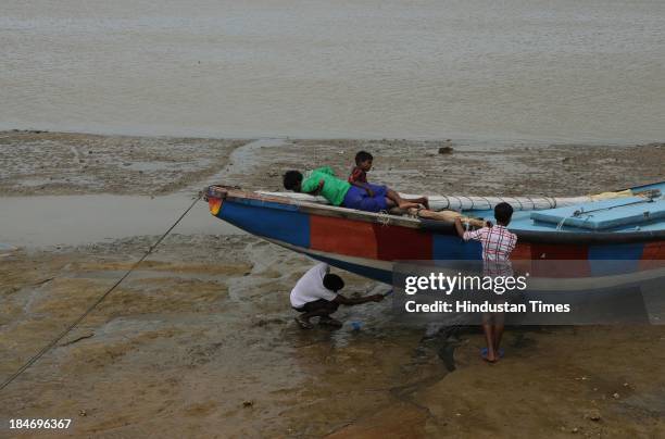 Indian fishermen repairing his boat on seacoasts at Gopalpur after the cyclone Phailin on October 15, 2013 in Chattapur, India. Cyclone Phailin on...