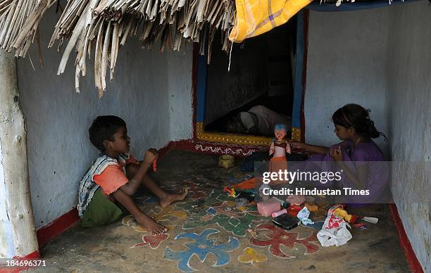 Children playing with toys in front of their hut after the cyclone Phailin on October 15, 2013 in Chattapur, India. Cyclone Phailin on Sunday left a...