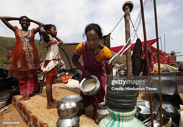 Indian fisher family salvage materials from their house damaged during Cyclone Phailin at the fishermen's village New Podampetta on October 15, 2013...