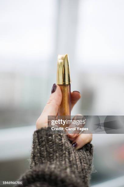 hand holding gold makeup - cosmetics bag stock pictures, royalty-free photos & images