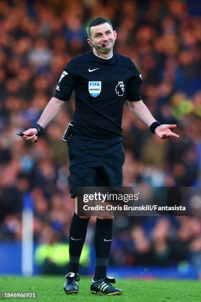 Referee Michael Oliver gestures during the Premier League match between Everton FC and Chelsea FC at Goodison Park on December 10, 2023 in Liverpool,...