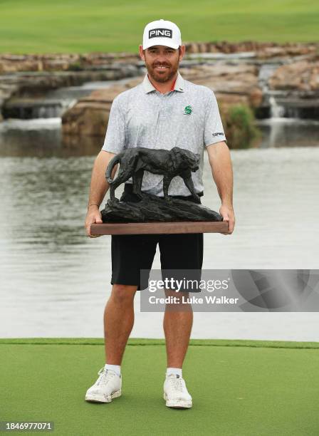 Louis Oosthuizen of South Africa poses with the Alfred Dunhill Championship trophy on Day Five of the Alfred Dunhill Championship at Leopard Creek...