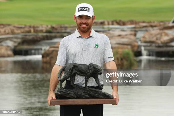 Louis Oosthuizen of South Africa poses with the Alfred Dunhill Championship trophy on Day Five of the Alfred Dunhill Championship at Leopard Creek...