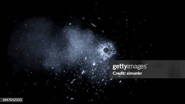 bullet hole on glass - bullet hole stock pictures, royalty-free photos & images